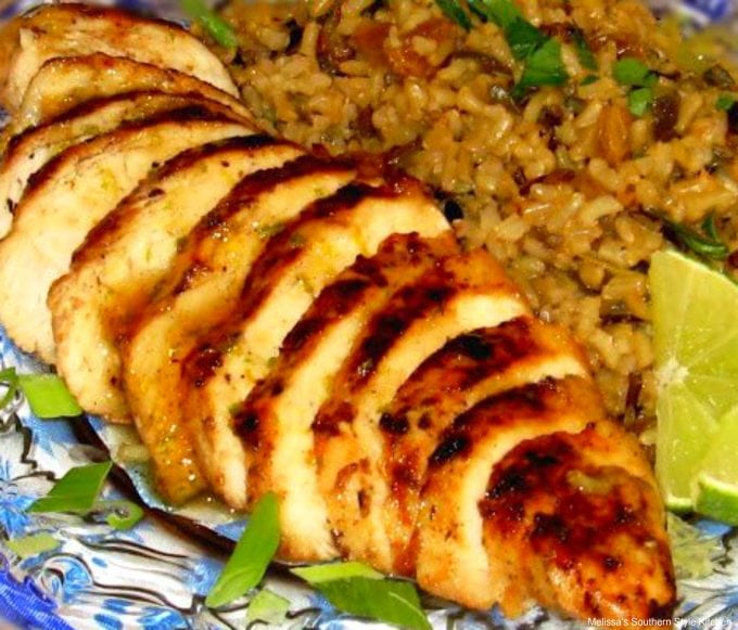 Caribbean Chicken sliced on a plate with rice pilaf