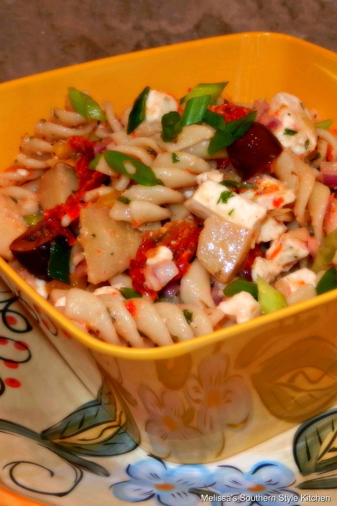 Greek Pasta Salad in a serving bowl on a plate