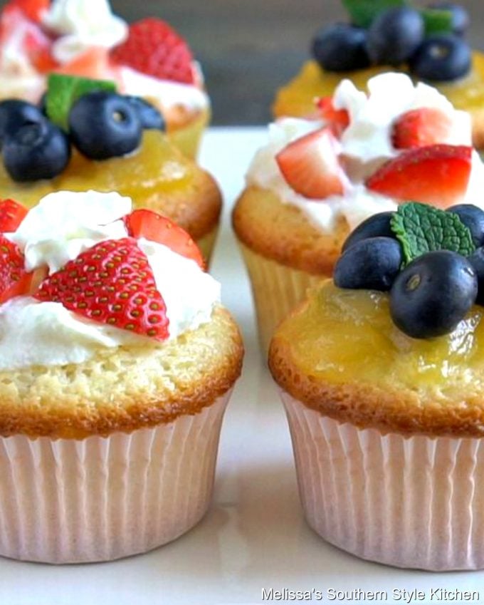 Cupcakes filled with whipped cream and berries on a plate
