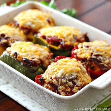 Stuffed Peppers topped with tomato glaze and cheese in a baking dish