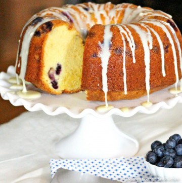 White Chocolate Blueberry Pound Cake on a cake stand