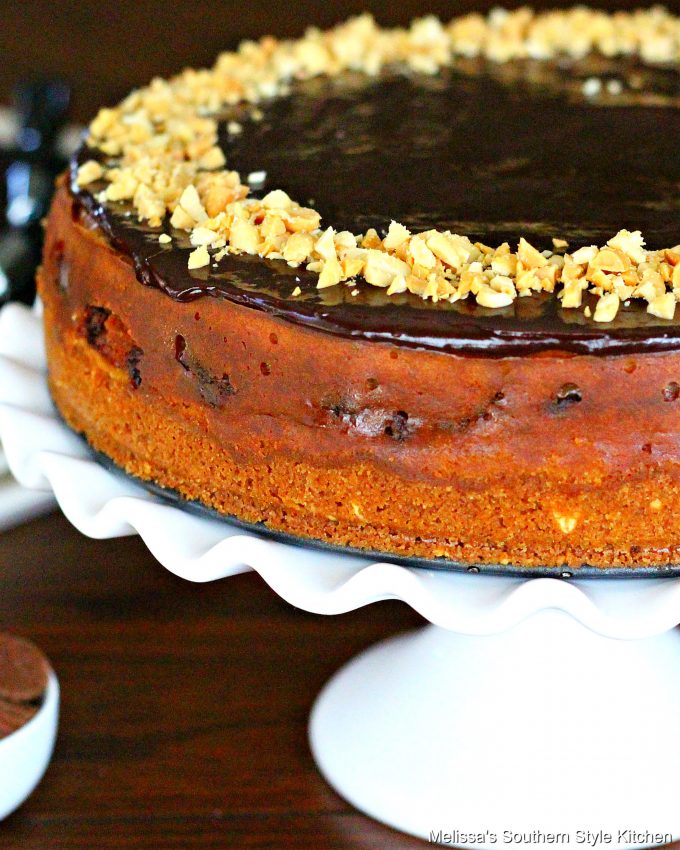 Peanut Butter Cup Cheesecake on a white cake pedestal