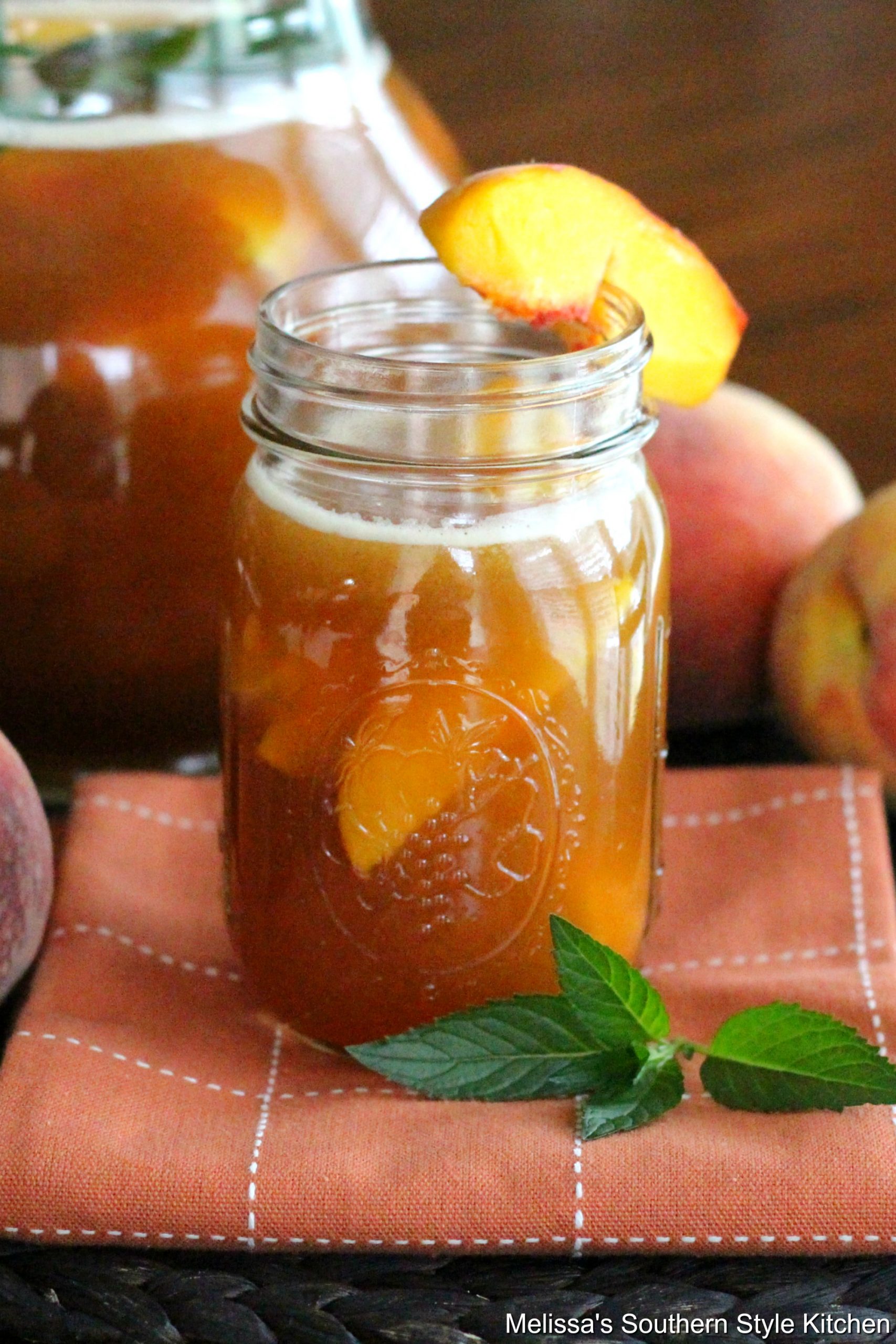 Peach Iced Tea in a mason jar with a peach slice
