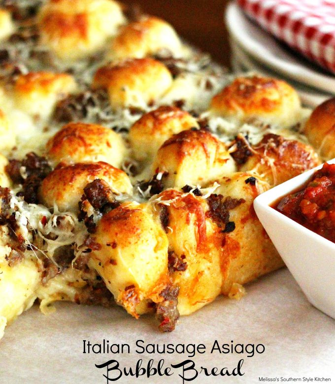 Italian Sausage Asiago Bubble Bread with marinara sauce on parchment paper