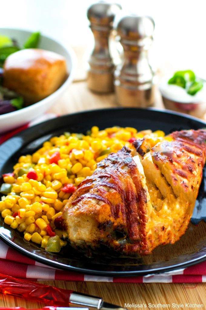 Jalapeno popper chicken on a plate with corn and salad
