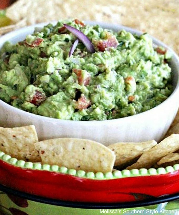 Fresh Guacamole in a bowl with tortilla chips