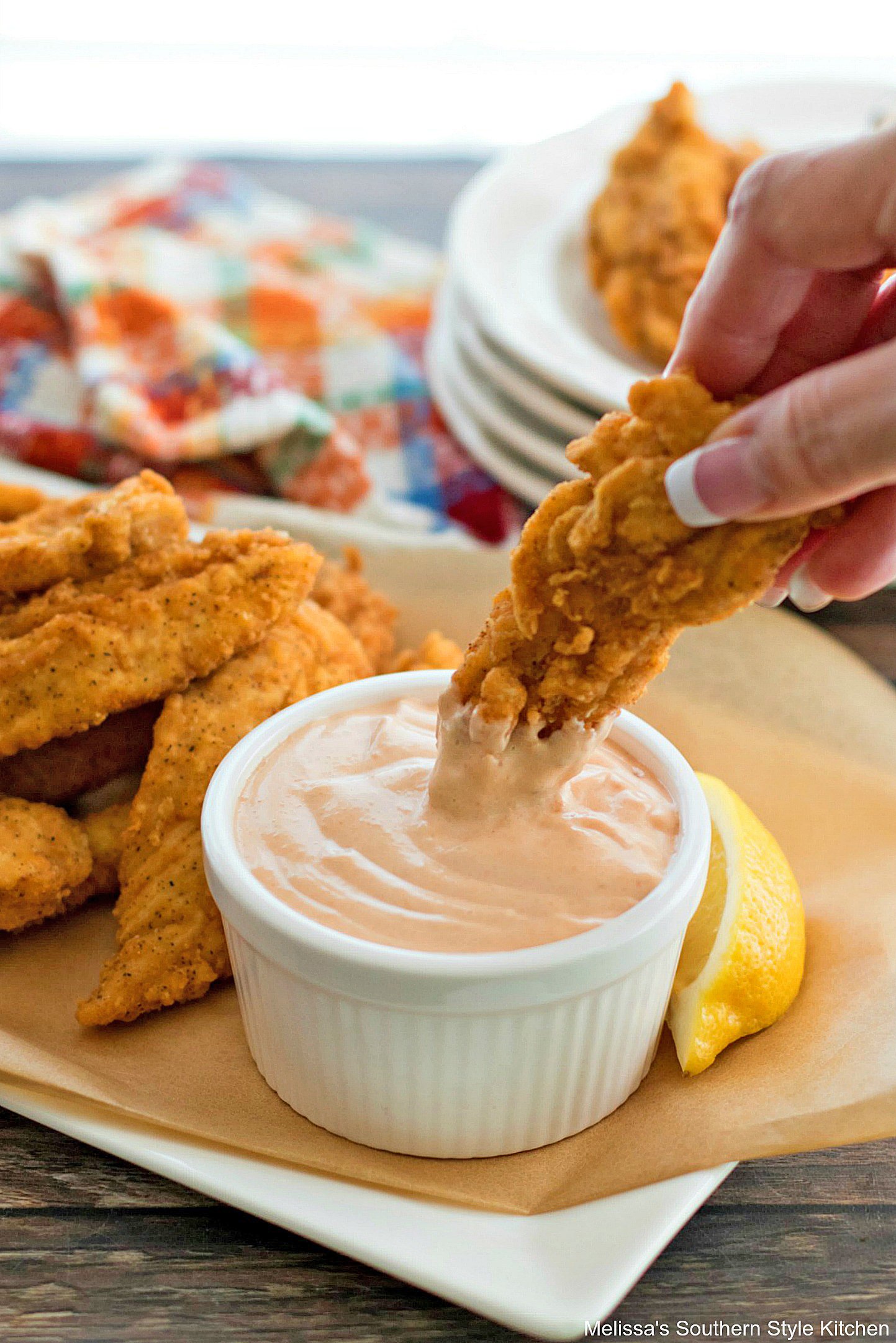 dipping chicken in Comeback Sauce 