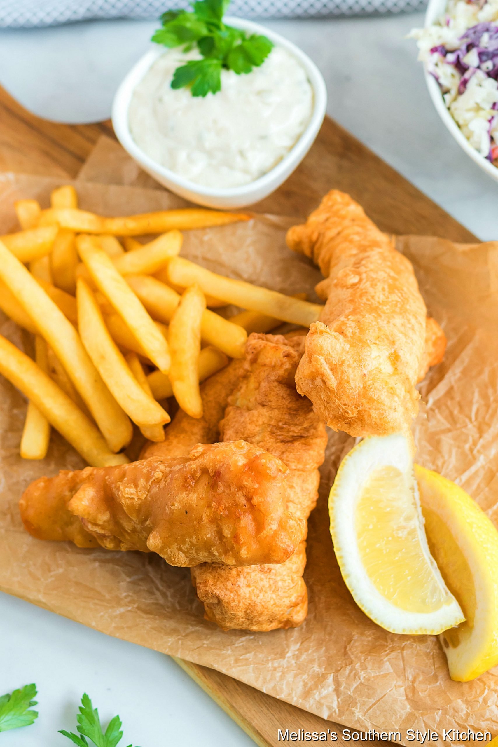 Beer Battered Fish and chips with tarter sauce on a platter