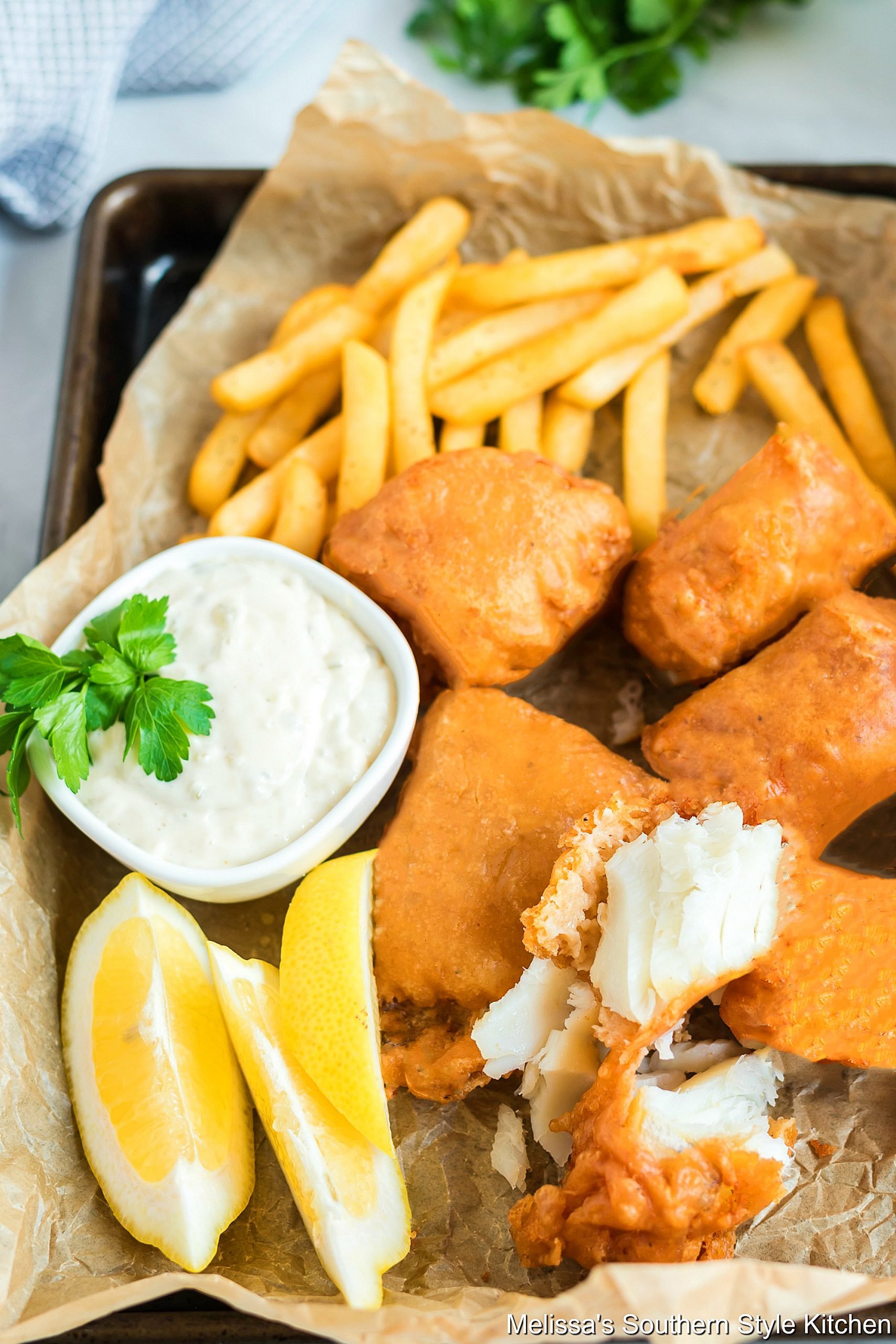 Flaky fried fish with french fries and tarter sauce