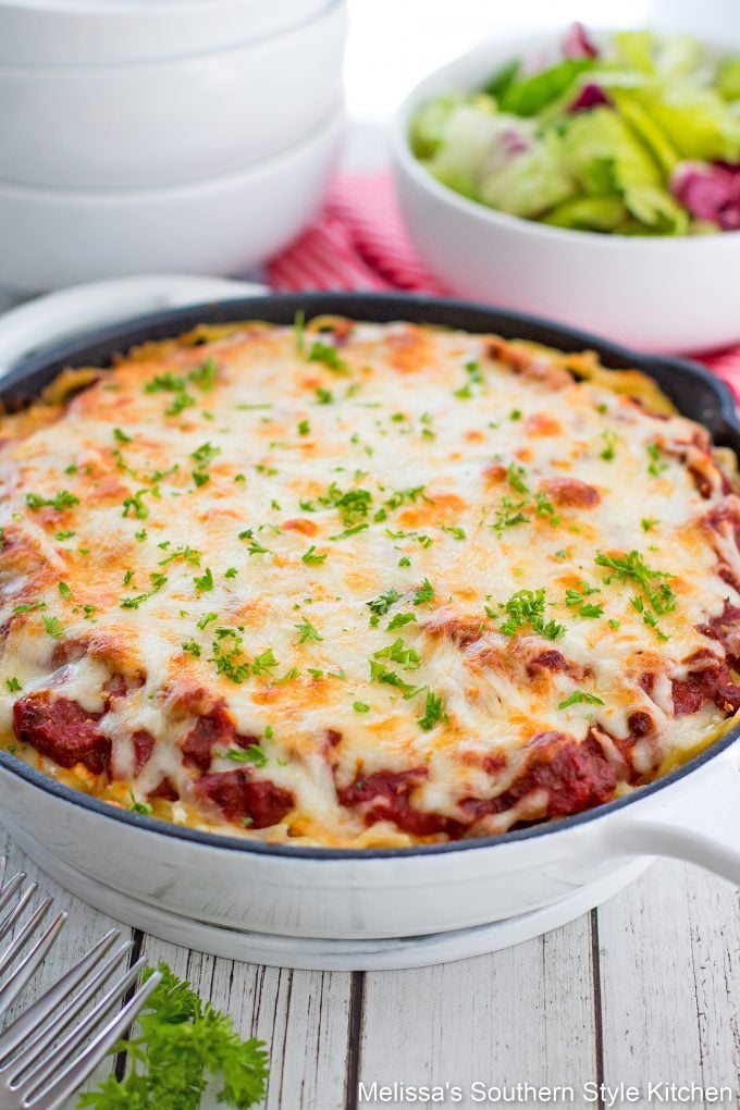 Spaghetti Pie in a skillet with pasta dishes