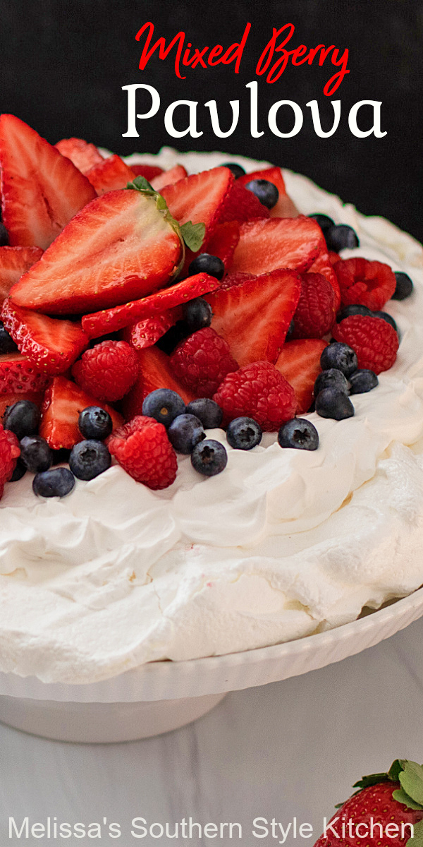 This billowy Mixed Berry Pavlova is a decadent dessert that's suitable for casual dining or entertaining #pavlova #mixedberries #easypavlova #pavlovarecipe #homemadewhippedcream #easydesserts #desserts #dessertfoodrecipes #southernrecipes