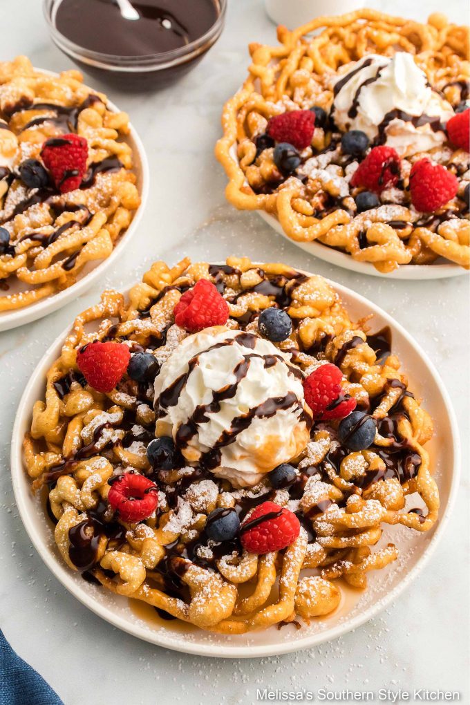 Funnel Cakes with chocolate syrup and berries